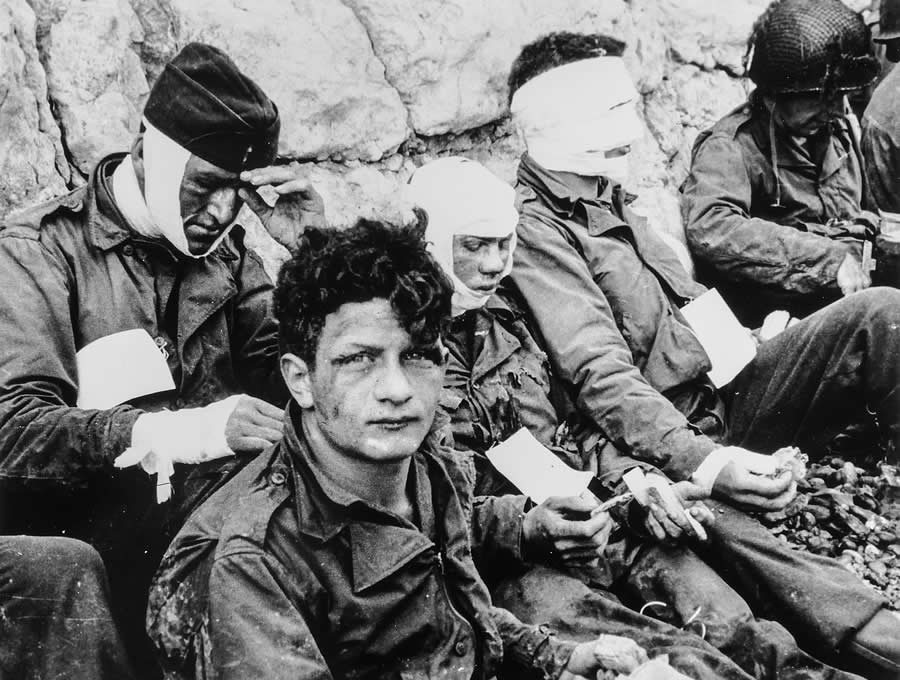 American Assault Troops of the 16th Infantry Regiment, Injured While Storming Omaha Beach, Wait by the Chalk Cliffs for Evacuation to a Field Hospital for Further Medical Treatment, Collville-sur-Mer, Normandy, France, June 6, 1944.