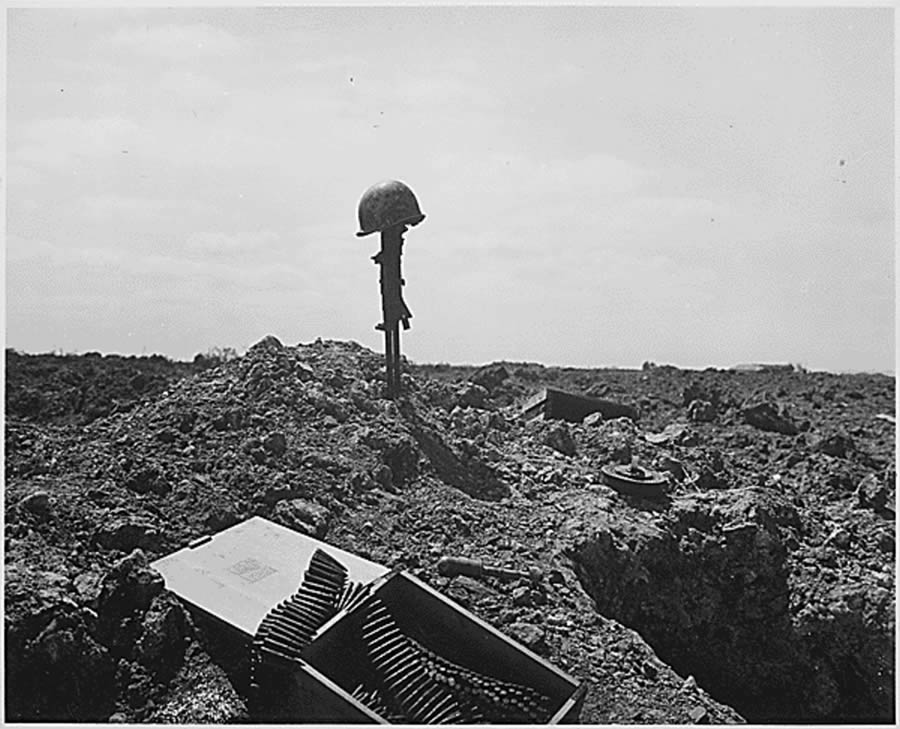 The beachhead is secure, but the price was high. A Coast Guard Combat Photographer came upon this monument to a dead American soldier somewhere on the shell-blasted shore of Normandy, ca. June 1944.