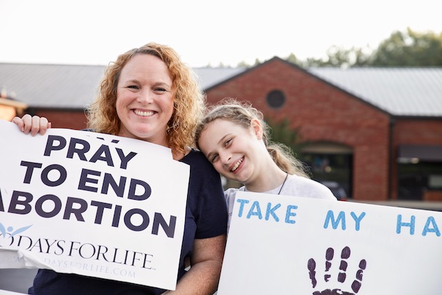 A mother and daughter participate in a 40 Days for Life prayer vigil. The nonprofit group reports that volunteers in 415 cities participated during their latest campaign this past fall.