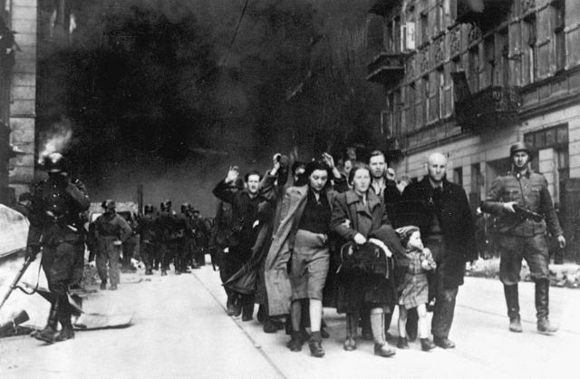 Captured Jews are led by German troops to the assembly point for deportation. Warsaw, Poland 1943