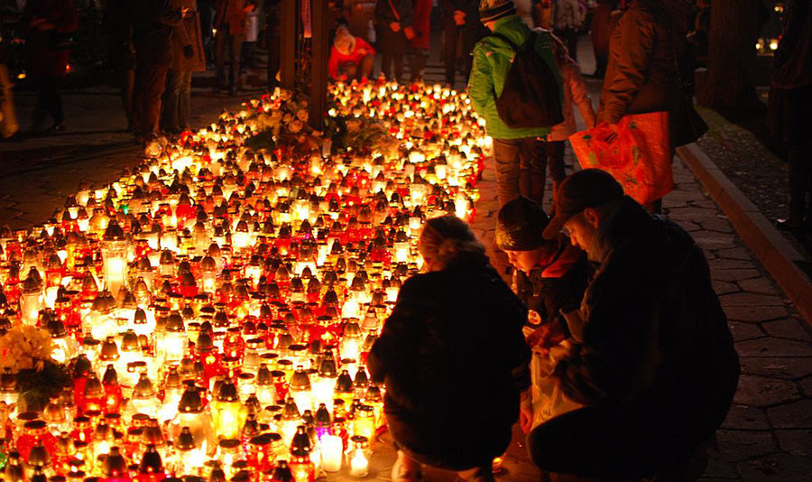 Families gather to remember and pray for deceased family members on All Saints Day at Old Cemetery in Łódź, Poland.