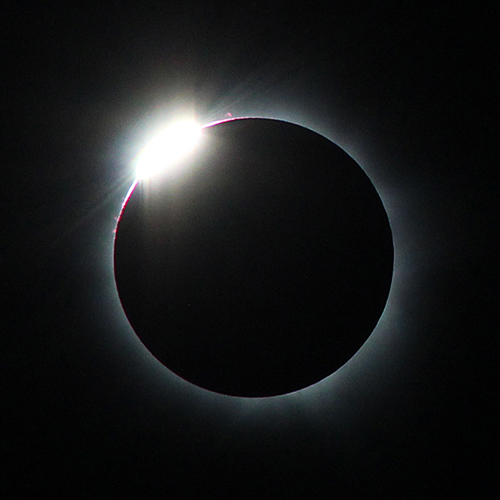 One of the most beautiful sights associated with a total solar eclipse is the "diamond ring." It appears just before the beginning of totality, when a single bright point of sunlight — the diamond — shines through a deep valley on the Moon's limb (edge) and the inner corona — the ring — becomes visible. As the diamond vanishes, it's safe to remove your solar filters. A second diamond ring appears at the end of totality when a deep valley on the opposite side of the retreating Moon exposes a single bead of bright sunlight that begins to wash out the corona. Put your filters back on! 