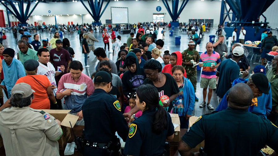 Flood victims gather for food at a shelter in the George R. Brown Convention Center during the aftermath of Hurricane Harvey on August 28, 2017 in Houston, Texas.