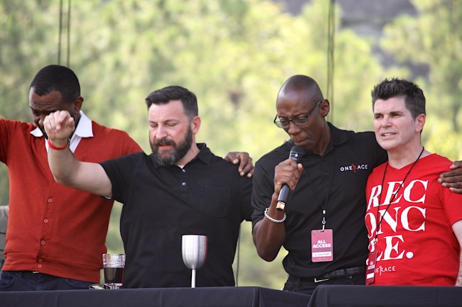 In a climatic moment of the OneRace Gathering, leaders pray before serving communion. L-R: Will Ford, Matt Lockett, Garland Hunt, Billy Humphrey.