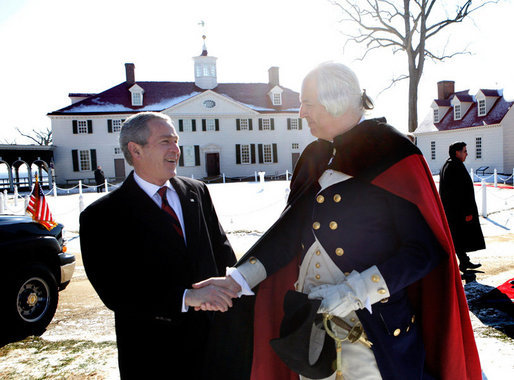 President George W. Bush shakes hands with General George Washington, played by actor Dean Malissa, following President Bush’s address at the Mount Vernon Estate, Monday, Feb. 19, 2007 in Mount Vernon, Va., honoring Washington’s 275th birthday. 
