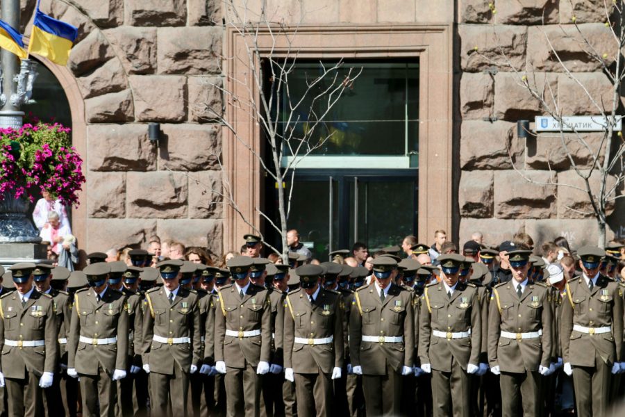Ukrainian troops bow their heads during a moment of silence to honor fallen soldiers.
