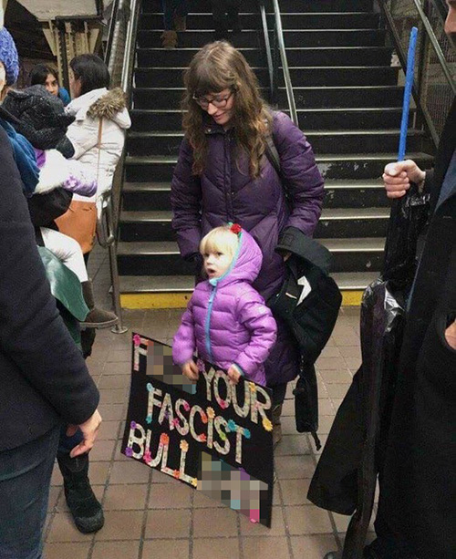 Little Girl with Profane Women's March sign - 500
