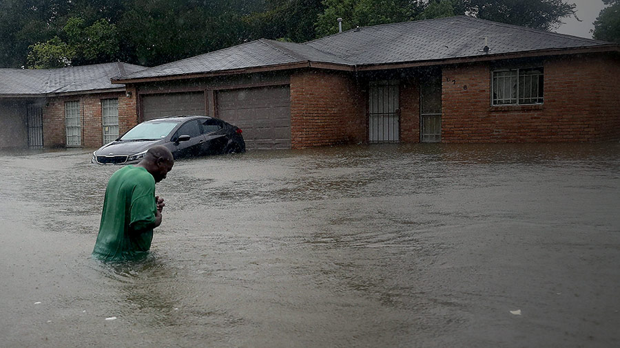 A person waits to be rescued from his flooded home after the area was inundated with flooding from Hurricane Harvey on August 28, 2017 in Houston, Texas.