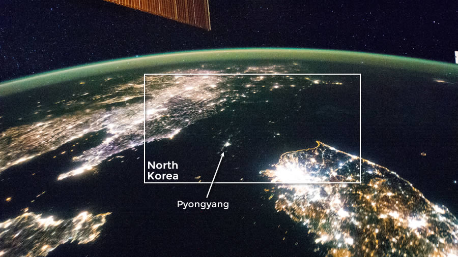 This Jan. 30, 2014, file photo shows the Korean Peninsula at night. North Korea is almost completely dark compared to neighboring South Korea, left, and China, right. The darkened land of North Korea appears as if it were a patch of water between it's neighbors. The capital city, Pyongyang, appears like a small island, despite a population of 3.26 million (as of 2008).
