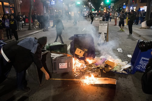  A demonstrator protesting Yiannopoulos sets a fire in Berkeley. (Photo: Noah Berger/EPA/Newscom) 