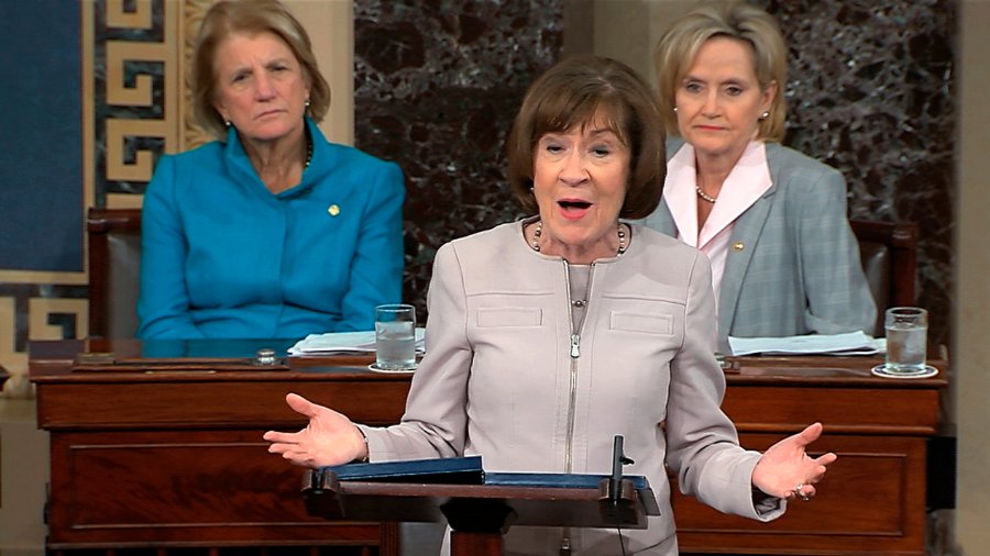 In this image from video provided by Senate TV, Sen. Susan Collins, R-Maine., speaks on the Senate floor about her vote on Supreme Court nominee Judge Brett Kananaugh, Friday, Oct. 5, 2018, in the Capitol in Washington. Sen Shelly Capito, R-W.Va., sits rear left and Sen. Cindy Hyde-Smith, R-Miss., sits right.