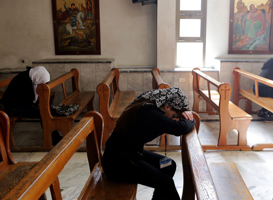 Displaced Assyrians, who had fled their hometowns due to Islamic State Group (ISIS) attacks against their communities, take part in a prayer at the Ibrahim-al Khalil Melkite Greek Catholic church in the Jaramana district on the outskirts of the capital Damascus on March 1, 2015. IS jihadists in Syria recently abducted at least 220 Assyrians, one the world's oldest Christian groups. Some 30,000 Assyrians lived in Syria before the start of the civil war in 2011.