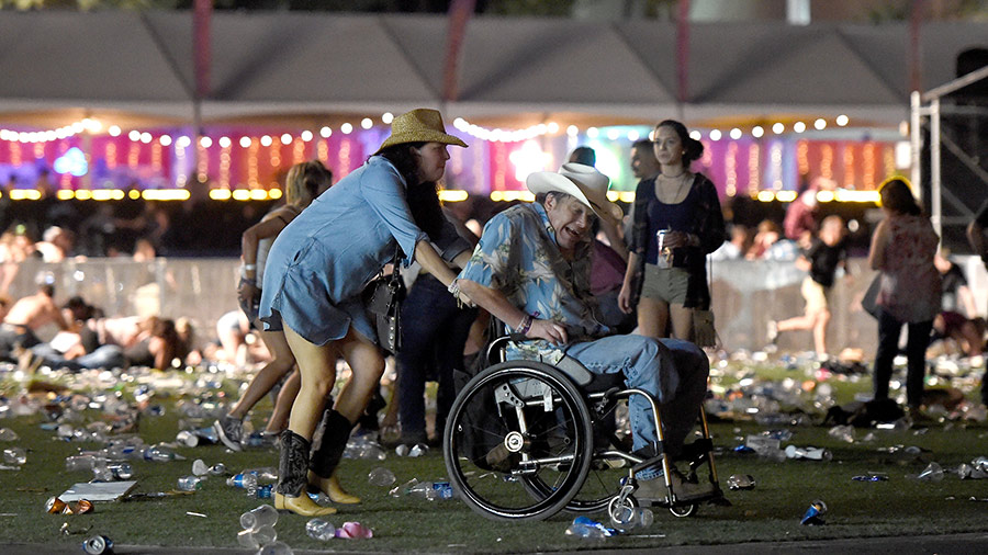 A man in a wheelchair is taken away from the Route 91 Harvest country music festival after gun fire was heard on October 1, 2017 in Las Vegas, Nevada. 